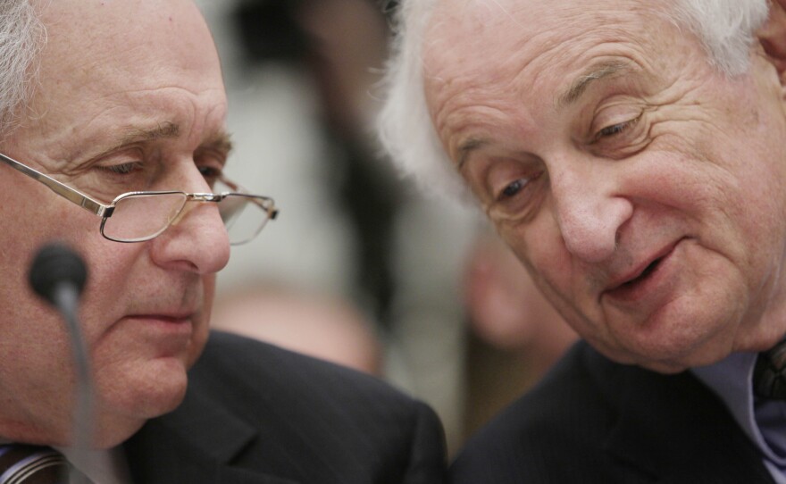 Carl Levin, left, huddles with his Sandy.