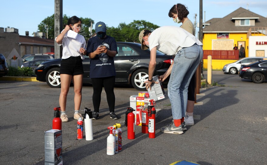Residents are given fire extinguishers in case protesters set businesses ablaze as they have in Minneapolis and across the nation.