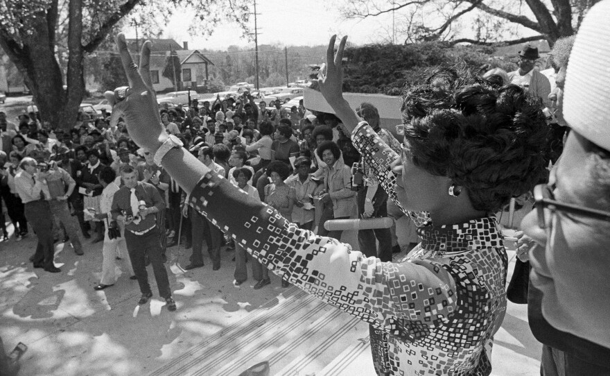 Shirley Chisholm makes victory signs as she addresses a crowd of several hundred in Florida while campaigning for the presidential primary in 1972.