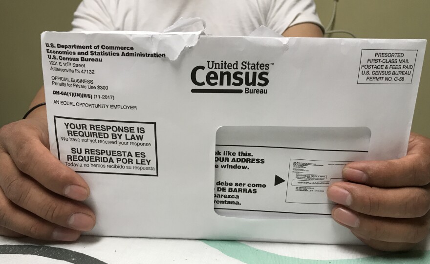A Rhode Island resident holds an envelope he received for the 2020 census test run in Providence County.