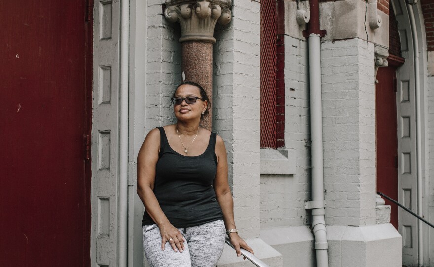 Patricia Rodriguez, a former parishioner and organizer of the informal mass outside Our Lady Queen of Angels, stands in front of the church. She was once led out of the church in handcuffs by the police after protesting its closing.