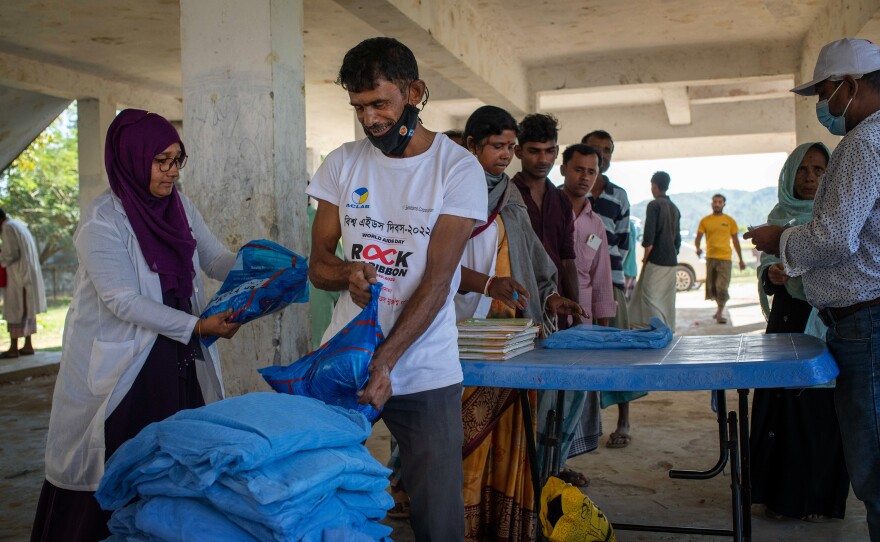 Bed nets treated with insecticide to ward off mosquitoes are distributed in Chakaria, Cox's Bazar, Bangladesh.