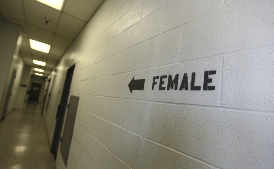 A sign points towards the women's section of the Huntington Beach jail. the National Council for Incarcerated and Formerly Incarcerated Women and Girls is appealing to President Biden to grant clemency to 100 women during his first 100 days in office.