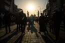 People walk toward the Kadhimiya Shrine at sunset in the Shia neighborhood in Baghdad, Tuesday.