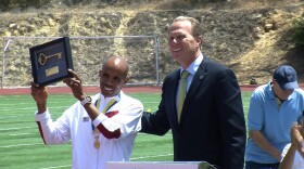 Boston Marathon winner Meb Keflezighi receives a key to the city of San Diego from Mayor Kevin Faulconer on Saturday, May 10, 2014.