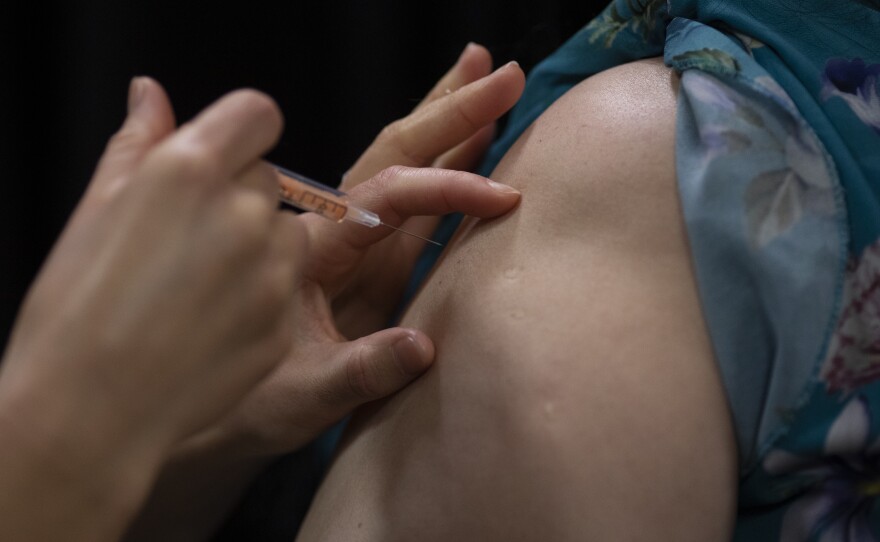 A patient gets the AstraZeneca vaccine on Wednesday in London.
