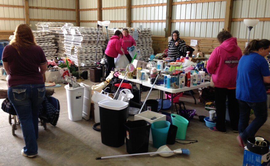 Families peruse the belongings left behind by DePauw students.