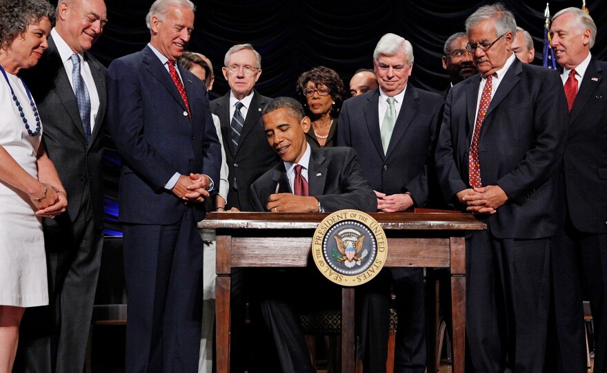 President Barack Obama signs the Dodd–Frank Wall Street Reform and Consumer Protection Act into law at the Ronald Reagan Building and International Trade Center on July 21, 2010, in Washington, D.C.