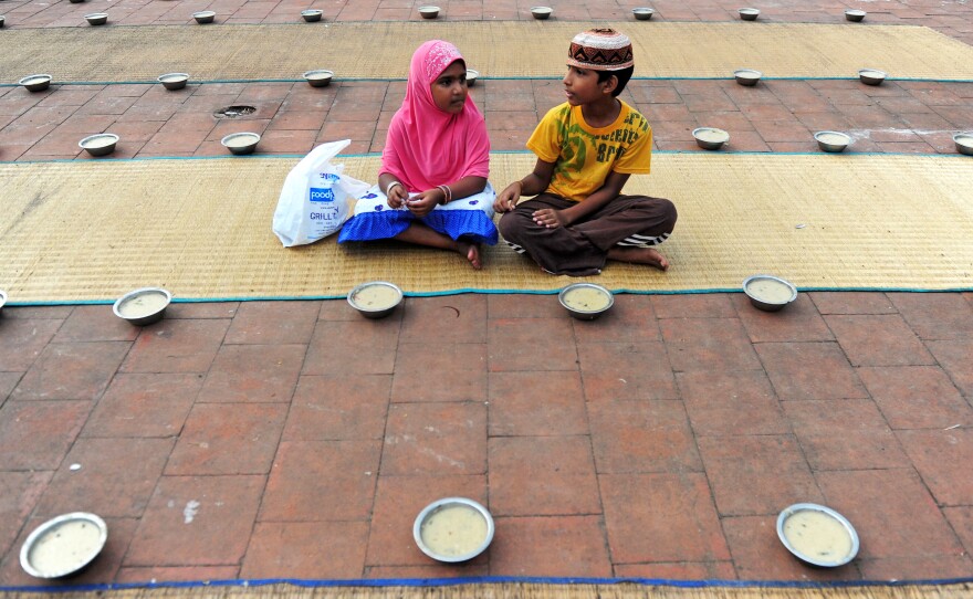 Young Indian children sit with bowls of porridge (nombu kanji) as they prepare to break the fast with the Iftar meal during the Islamic month of Ramadan at The Wallajah Big Mosque in Chennai last July.