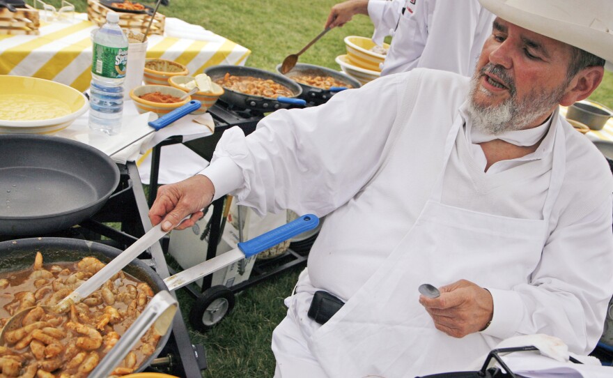 New Orleans Chef Paul Prudhomme prepares barbecue shrimp at the Annual White House Congressional Picnic in 2007.