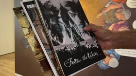Native comic book creator Chag Lowry holds up some of his past works inside the La Jolla Historical Society, July 17, 2025.