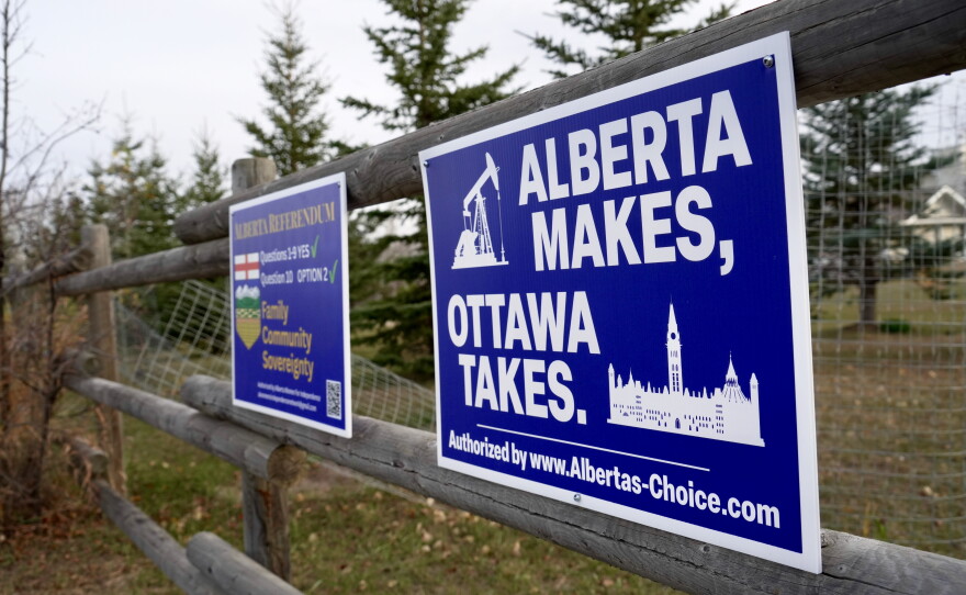Political signs are posted on a property's fence in Wainwright, Alberta, Canada, Monday, Oct. 19, 2026.