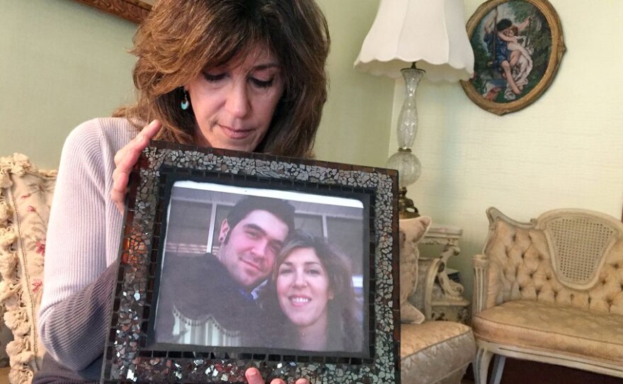 Debbie Deagle holds a photo of her son Stephen and herself.