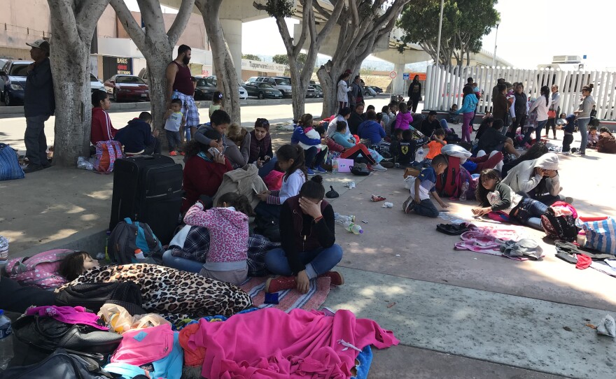 A group of people seeking asylum in the U.S. wait near the border in Tijuana, April 25, 2018.