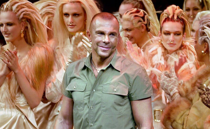 French designer Thierry Mugler acknowledges applause following his fall/winter 2001-2002 ready-to-wear collection presentation in Paris on March 12, 2001.