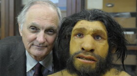 Alda cozies up to an ancient cousin, a Neanderthal, at the American Museum of Natural History.