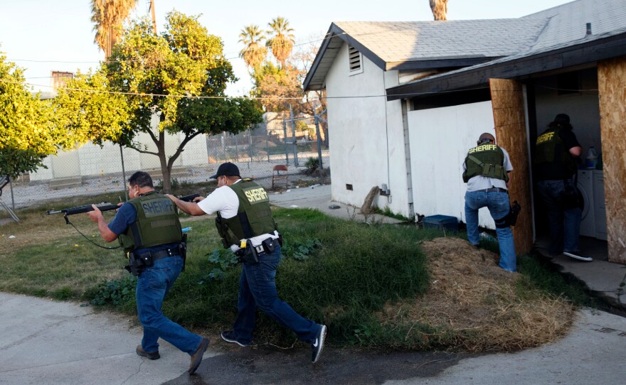 Authorities told people in a San Bernardino neighborhood to stay indoors as they searched the area.