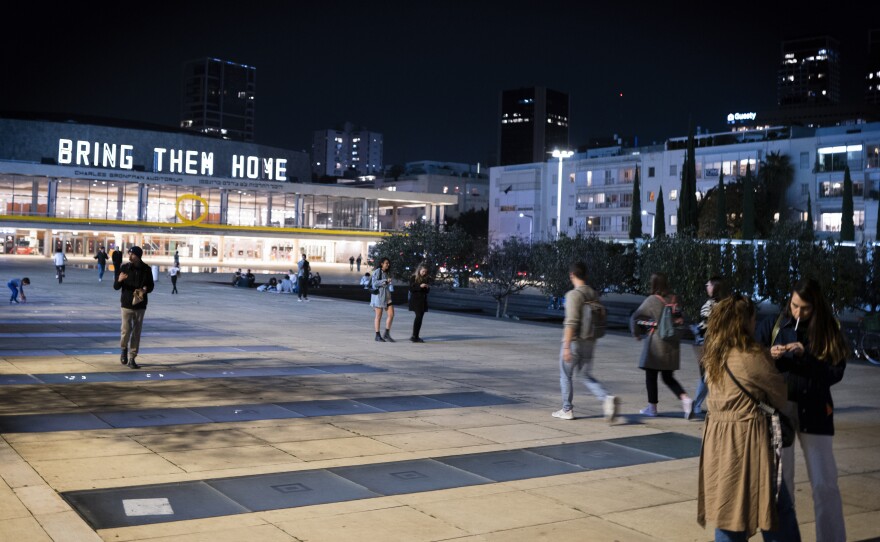 The National Theater of Tel Aviv is illuminated with signs that read "Bring Them Home," a reference to Hamas' hostages in Gaza.