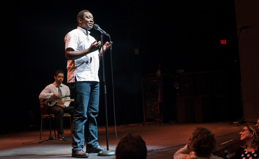 Dr. Thumbi Mwangi, an infectious disease epidemiologist from Kenya, speaks at the Moth Slam event at Howard Theatre in Washington, D.C. on Nov. 29, 2016.