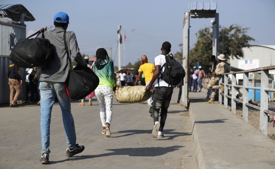 Haitian citizens cross over the border from the Dominican Republic into Haiti on Wednesday.