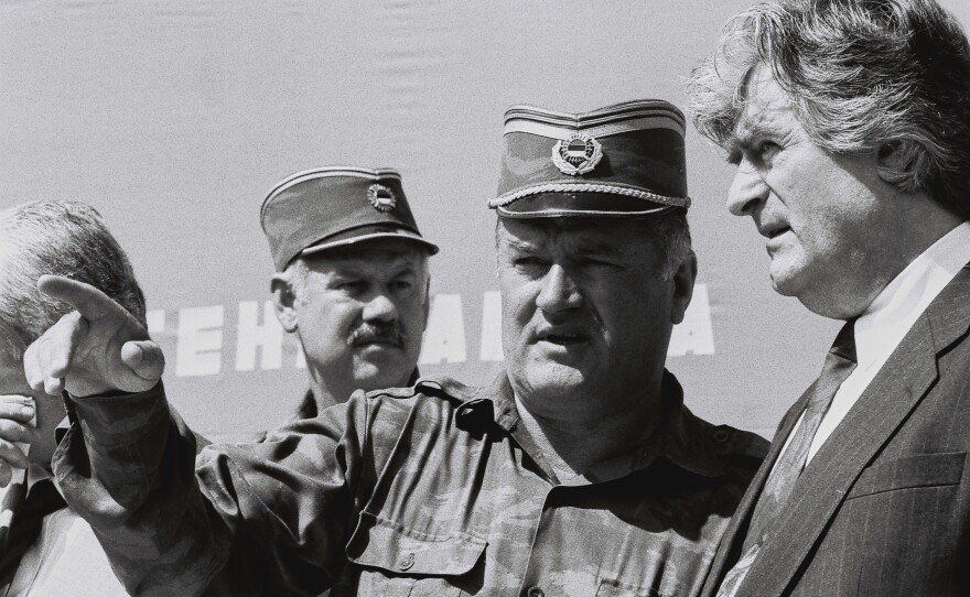 Bosnian Serb General Ratko Mladic (center) speaks with Bosnian Serb President Radovan Karadzic (right) in the Bosnian town of Banja Luka, in 1994.
