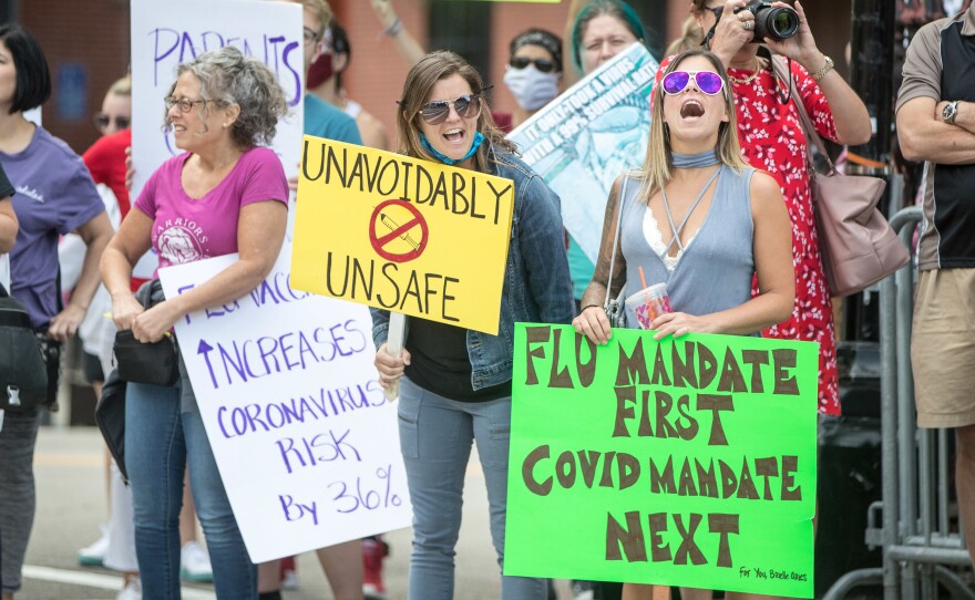 Anti-vaccine activists protested at the Massachusetts State House in August against Governor Charlie Baker's mandate that all students enrolled in child care, pre-school, K-12, and post-secondary institutions must receive the flu vaccine this year.