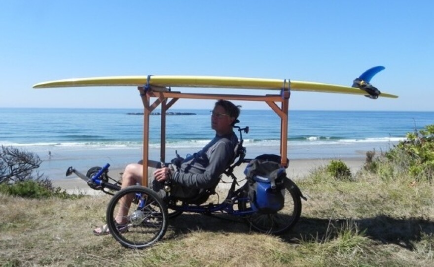 Ed Gunderson built a surfboard rack for his recumbent tricycle, which he's riding here on Beverly Beach in Oregon.