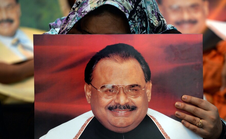 Supporters of Pakistani politician Altaf Hussain hold photographs of him at a sit-in in Karachi. The city, home to more than 20 million, has largely ground to a halt since his arrest Tuesday in London. Hussain is the leader of the Muttahida Qaumi Movement, or MQM.