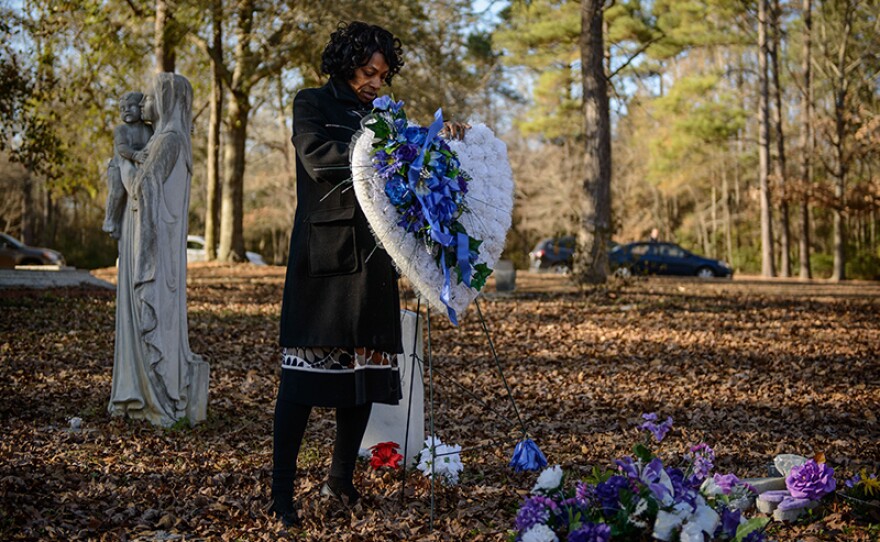 Claudia Lacy visits her son Lennon's grave.