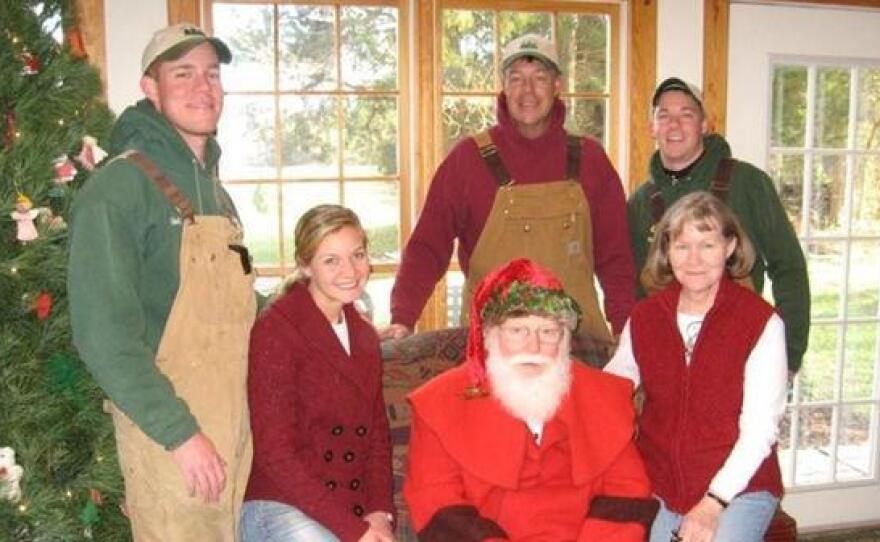 The Carroll family has turned the holiday season into their family business. The family is pictured here with Santa, who visits their Christmas tree farm on weekends in December.