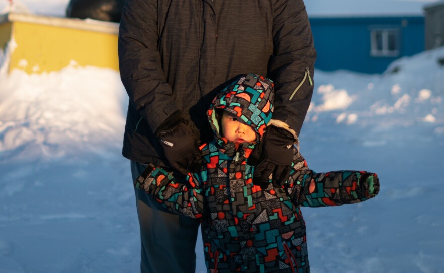 Maria White and her son Lance Jimmie, 3, stand near their home in Toksook Bay. White works at Bayview General Merchandise, one of the three convenience stores in Toksook Bay.