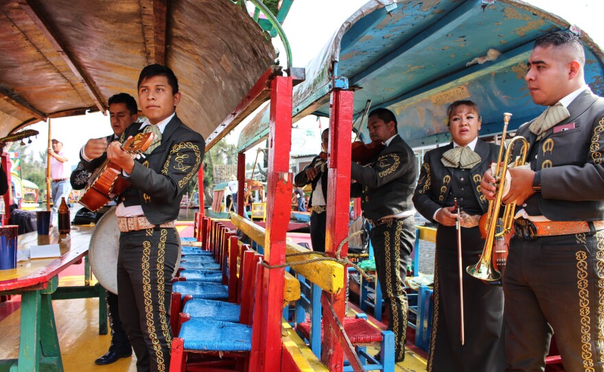 A mariachi band waiting to perform songs of your choosing from their trajineras.