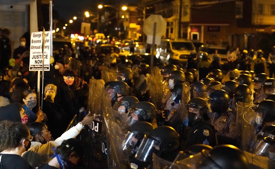Protesters confront police during a march in Philadelphia on Tuesday, following the death of Walter Wallace, a Black man who was killed by police in the city on Monday.