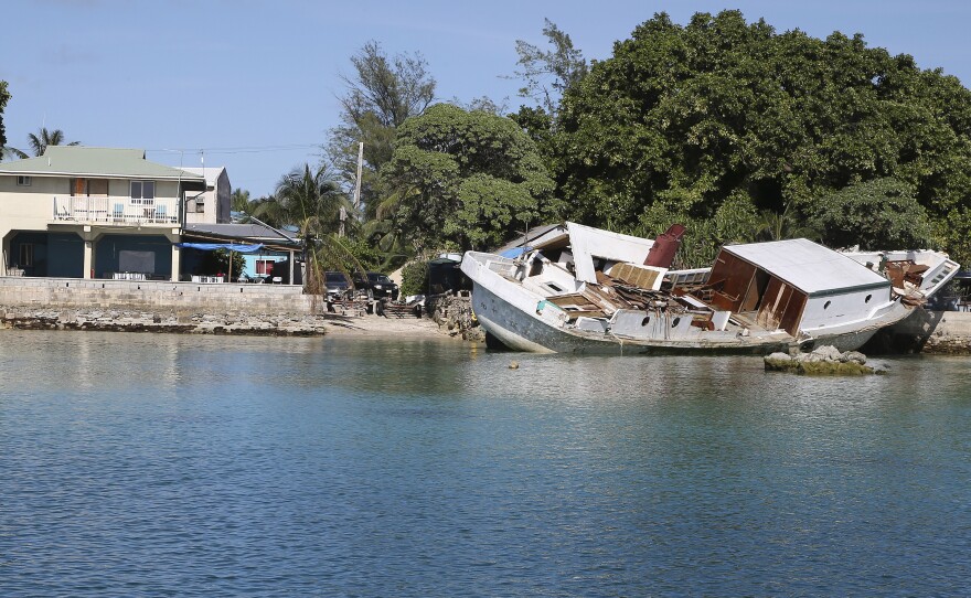 A boat lies wrecked and stuck on a sea wall after it crashed into the back of de Brum's house on Majuro Atoll in the Marshall Islands. A huge tide hit the atoll on July 3, causing massive flooding and damage. Climate change is causing sea levels to rise and is leading to more extreme weather, according to climate scientists.