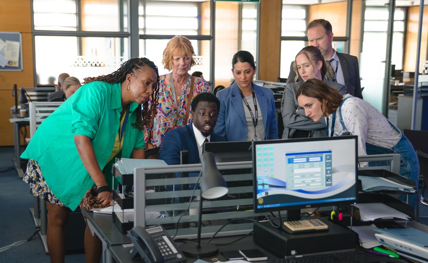 Shown L-R: Suzie Harris (Jo Martin), Judith Potts (Samantha Bond), DC Jason Kennedy (Tijan Sarr), DS Tanika Malik (Natalie Dew), DC Alice Hakett (Holli Dempsey), DS Brendan Perry (Phill Langhorne), Becks Starling (Cara Horgan) in MASTERPIECE: THE MARLOW MURDER CLUB, Season 2 Episode 4.