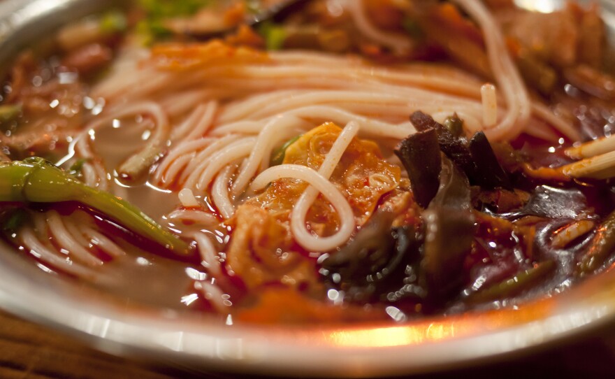 A Chinese street stall serves up a bowl of snail noodles.