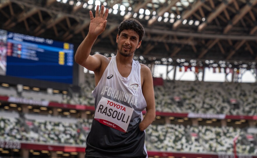 Hossain Rasouli of Team Afghanistan waves after competing in the Men's Long Jump-T47 Final at the Tokyo Olympic Stadium on Tuesday. He and teammate Zakia Khudadadi managed to get to Tokyo despite the turmoil in their home country.