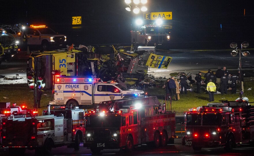 A Port Authority aircraft rescue and firefighting vehicle lays on its side off of runway 4 after colliding with an Air Canada jet after it landed at LaGuardia Airport, Monday, March 23, 2026, in New York.