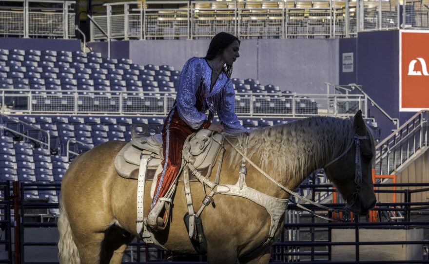 A woman in a shiny outfit sits on a horse at San Diego Rodeo inside Petco Park, Jan. 15, 2026.