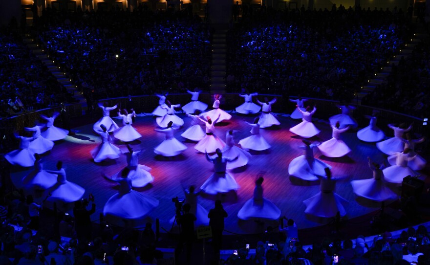 Whirling dervishes of the Mevlevi order perform during the Sheb-i Arus ceremony.