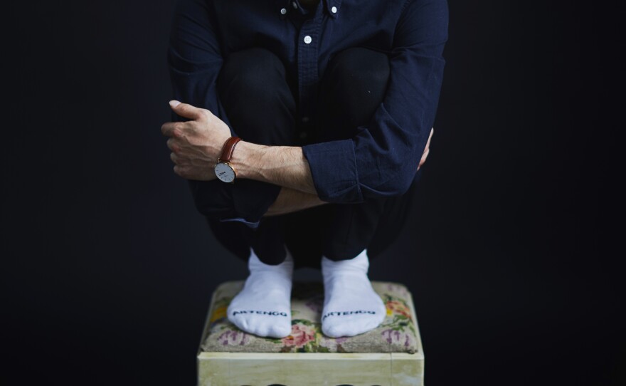 Alshogre demonstrates how he was forced to sit while in prison. He was arrested in 2012 at age 17 for joining a protest movement in his hometown of Bayda, on Syria's Mediterranean coast.