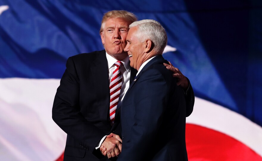 Trump congratulates his running mate, Pence, after his speech.