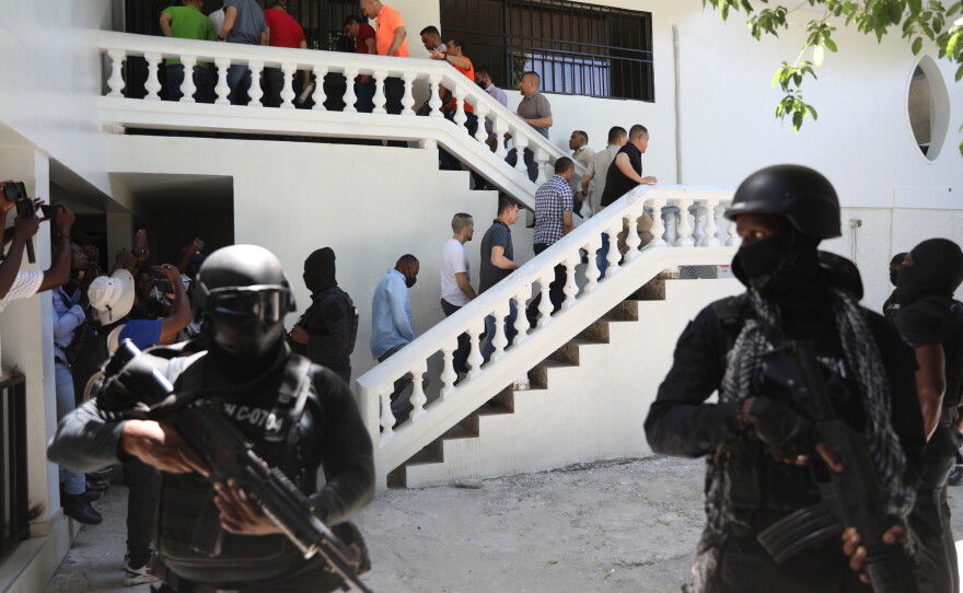 FILE - Colombians and Haitians who are accused of involvement in the 2021 assassination of Haitian President Jovenel Moise are escorted in handcuffs to their court hearing in Port-au-Prince, Haiti, May 26, 2025.