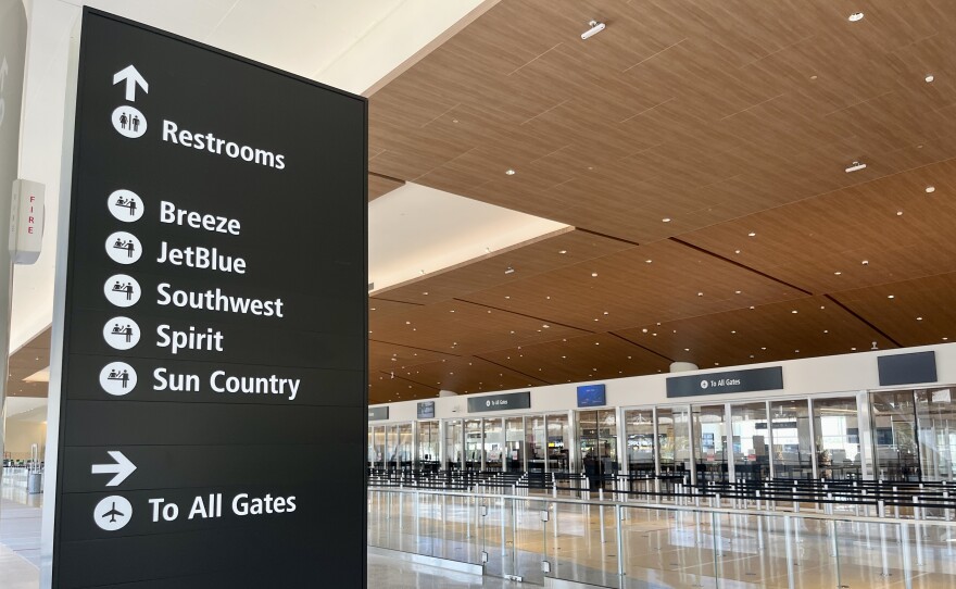 A sign with airline carriers point to gates inside San Diego's new Terminal 1, Aug. 27, 2025.