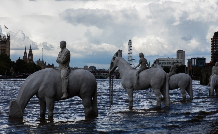 The Rising Tide, on the shore of Thames River in London. Each horse is a hybrid — half animal, half oil pump.