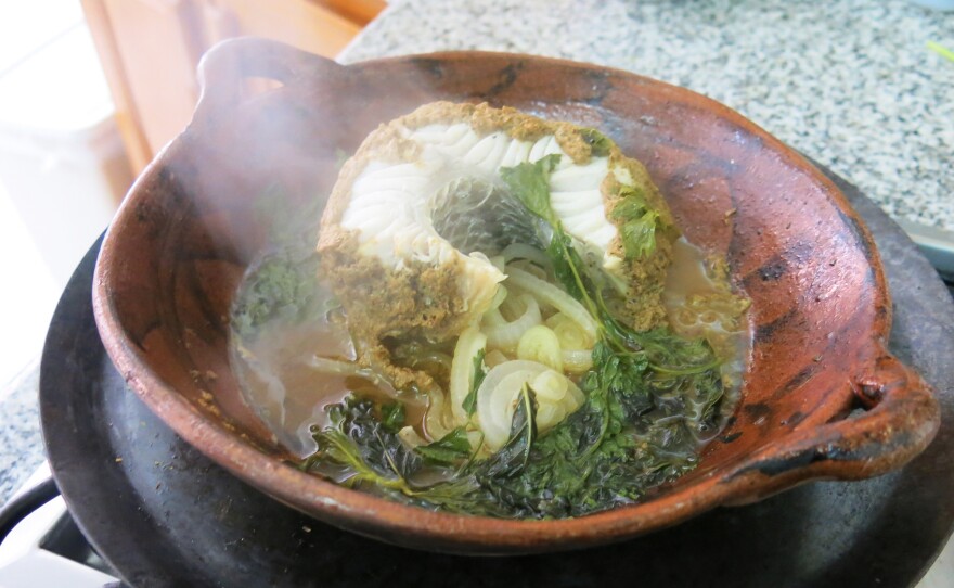 Carrillo and NPR's Carrie Kahn cooked robalo, or local snook, a firm white fish, in chintextle, a smoked chile marinade paste.
