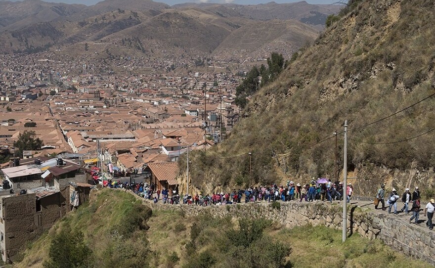 Families walk from the center of Cusco to a temple site at Sacsayhuaman to celebrate Inti Raymi, the Inca Festival of the Sun.