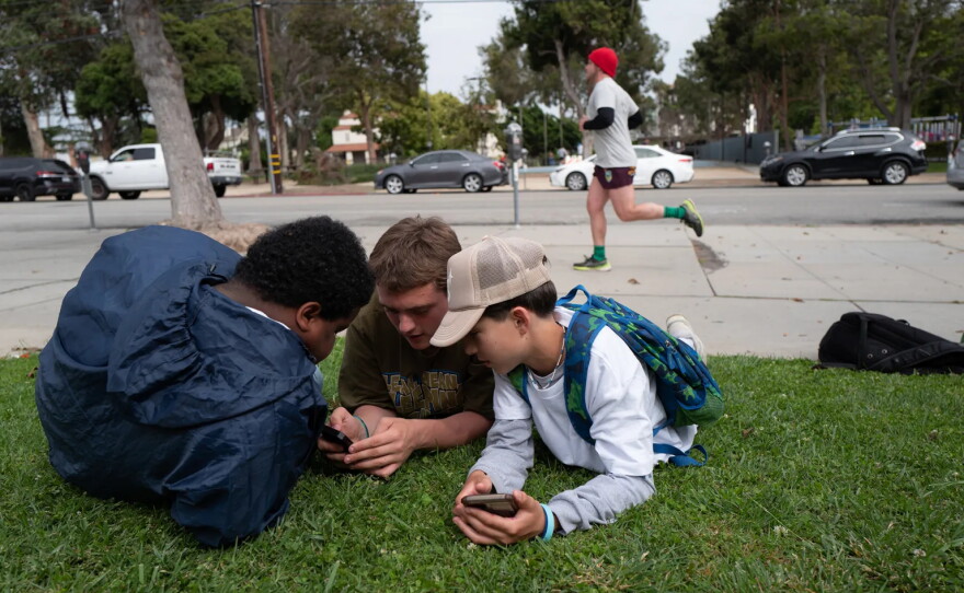 The California Legislature is considering bills to safeguard children from chatbots and curb addictive social media for kids. Students of Saint Monica Preparatory hang out after school in Santa Monica. May 24, 2023.
