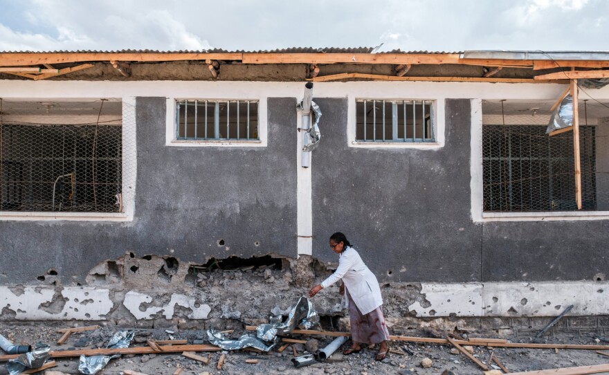 A nurse moves scrap from a damaged part of the Wukro General Hospital, which was shelled as government-aligned forces entered the city in the Tigray region of Ethiopia on February 28, 2021.