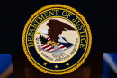 FILE - The U.S. Department of Justice logo is seen on a podium before a news conference, May 4, 2026, in Washington.